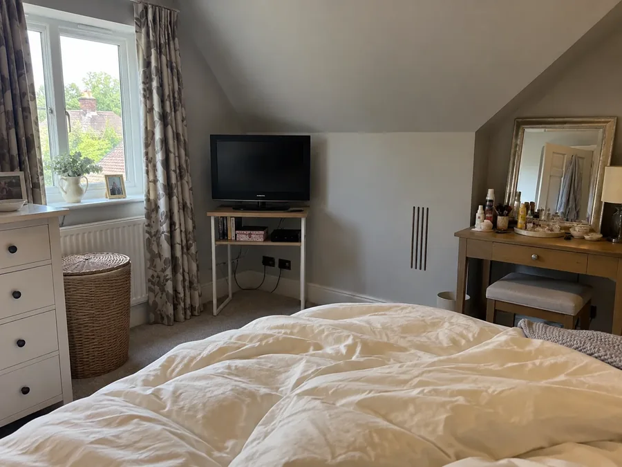 Bedroom with a wall-mounted television and the air conditioning fitted