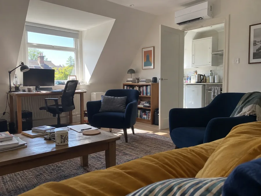 Attic sitting room and desk under the eaves with the air conditioning fitted