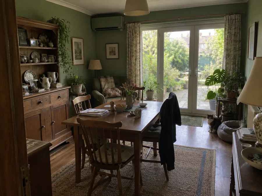 Dining room with green walls and garden doors, air conditioning fitted