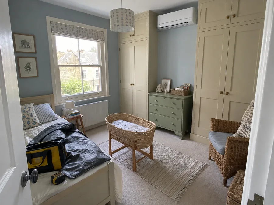 Small nursery with a moses basket, unit high on the wall