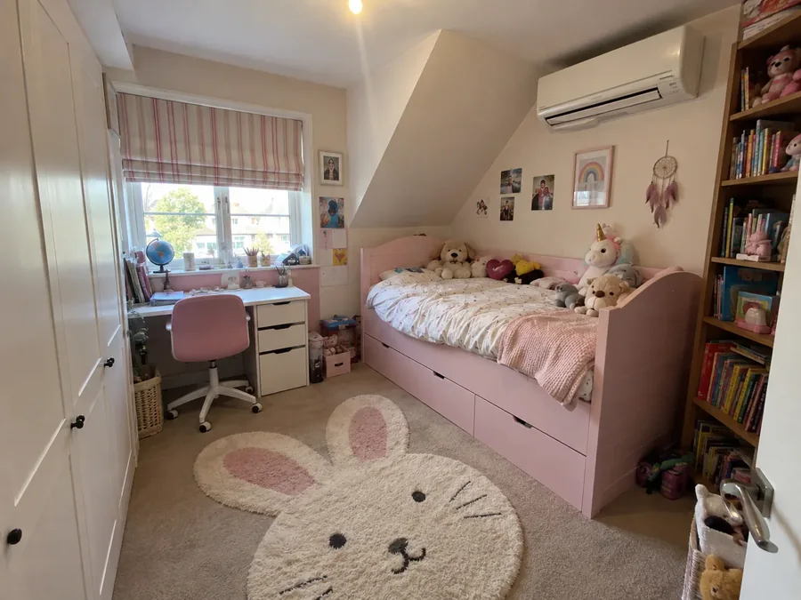 Child's room with a bed and desk and the air conditioning fitted