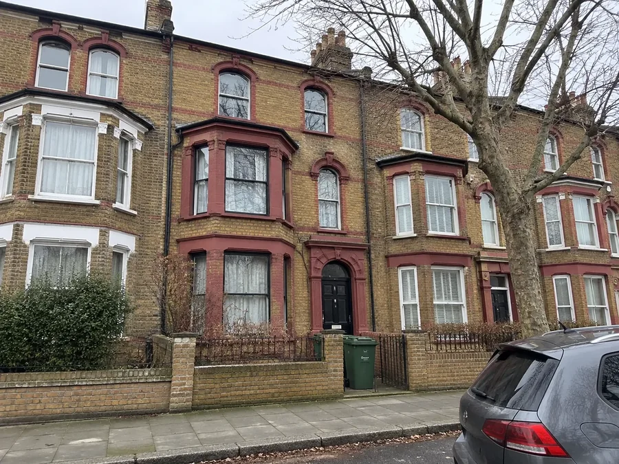 Street of red-brick Victorian houses with bay windows
