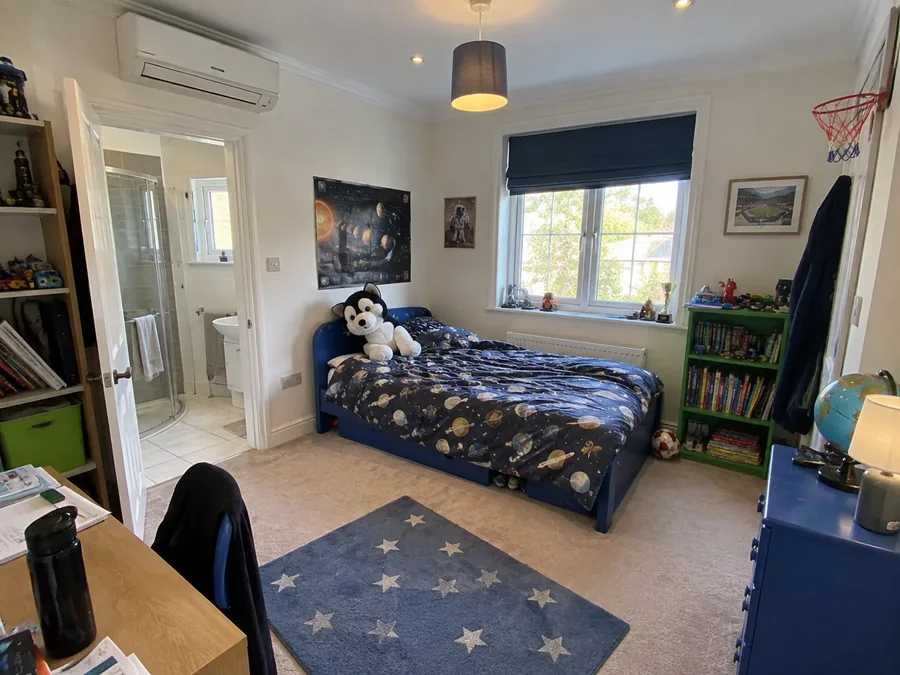 Child's bedroom with blue walls and the air conditioning fitted