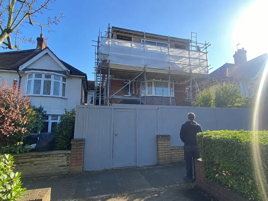 House under scaffolding and sheeting during a renovation
