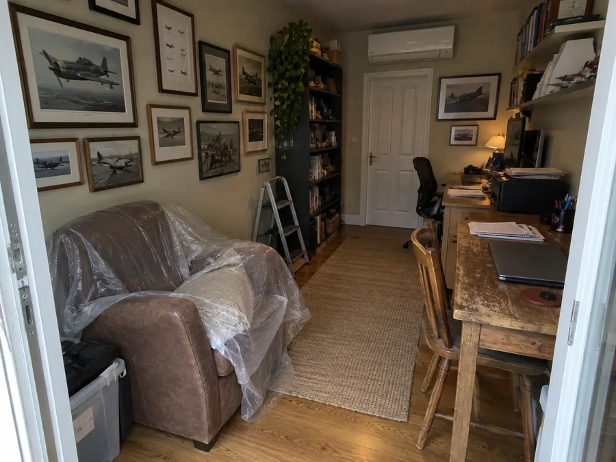 Home office with the furniture under dust sheets and the unit already fitted