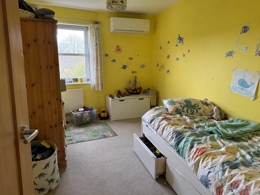 Playroom with yellow walls and the air conditioning fitted