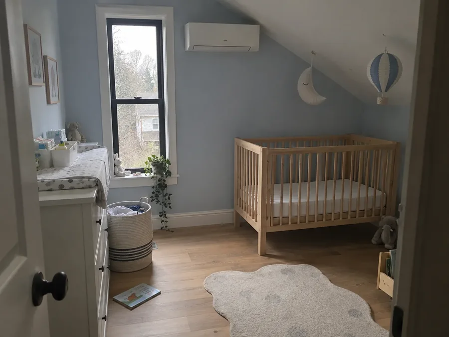 Nursery with a cot under the eaves, unit high on the sloping wall