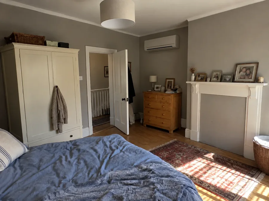 Bedroom with a freestanding wardrobe and the unit high on the far wall