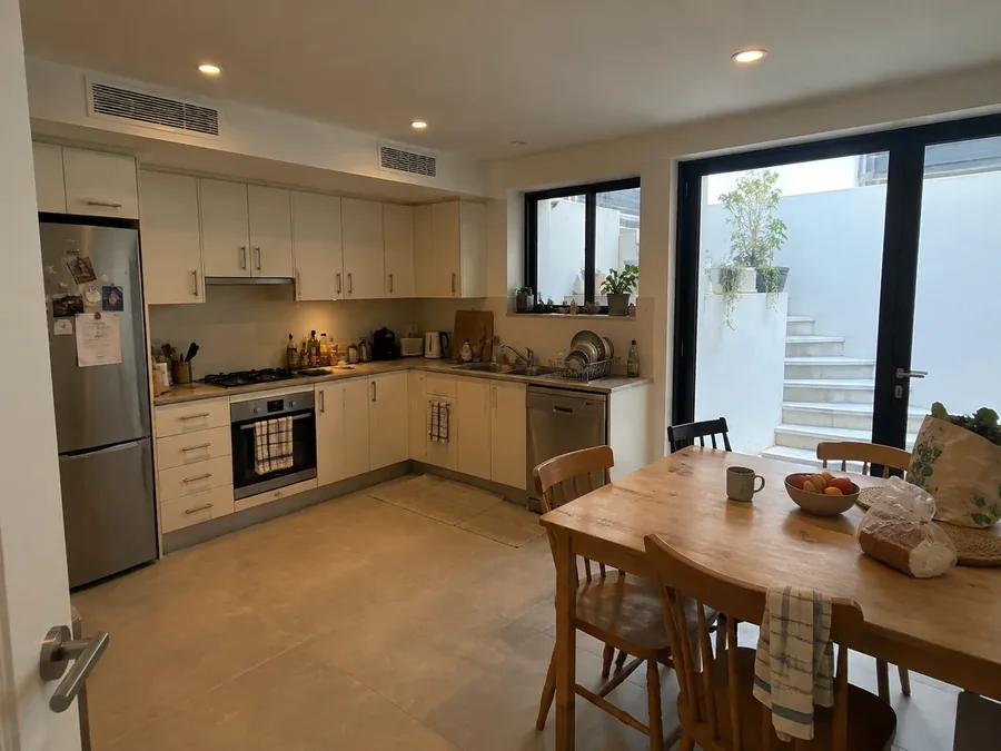 Basement kitchen and dining room, slim unit high on the wall above the cabinets